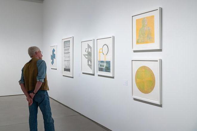 person looking at some of the prints on display